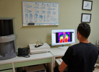 Dr. Wee reviewing patient's foot X-rays