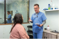 Dr. Hiller discussing care with a patient 1