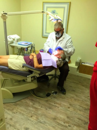 Dr. Deriana performing periodontal procedure in his dental clinic in Tucson AZ 3