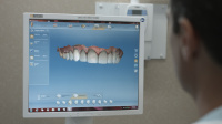 Dr. Alexander looking at a 3D image of a patient's teeth 3